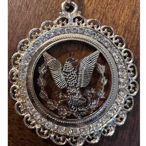 Vintage gold-tone eagle medallion pendant necklace w/clear rhinestone border.